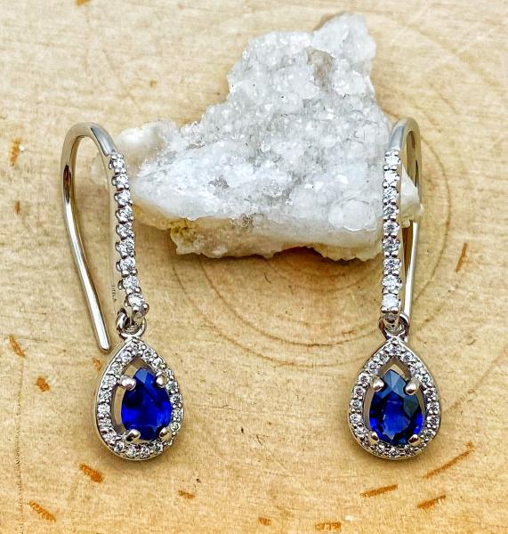 14 karat white gold blue sapphire and diamond halo dangle earrings. $1900.00
