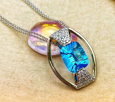 18 karat white and rose gold concave faceted cushion Swiss blue topaz and diamond necklace.$2150.00