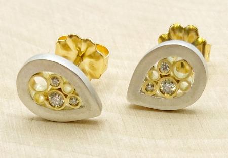 Sterling silver and 18 karat yellow gold diamond tear drop stud earrings. $1130.00