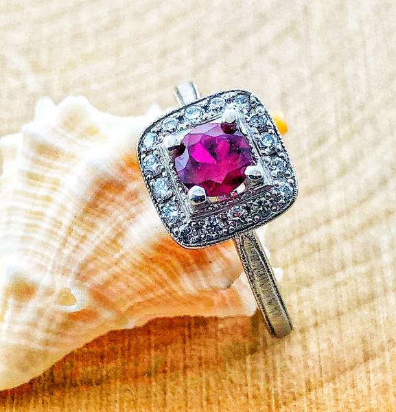 14 karat white gold cushion diamond halo ring with a Madagascar ruby. $1780.00