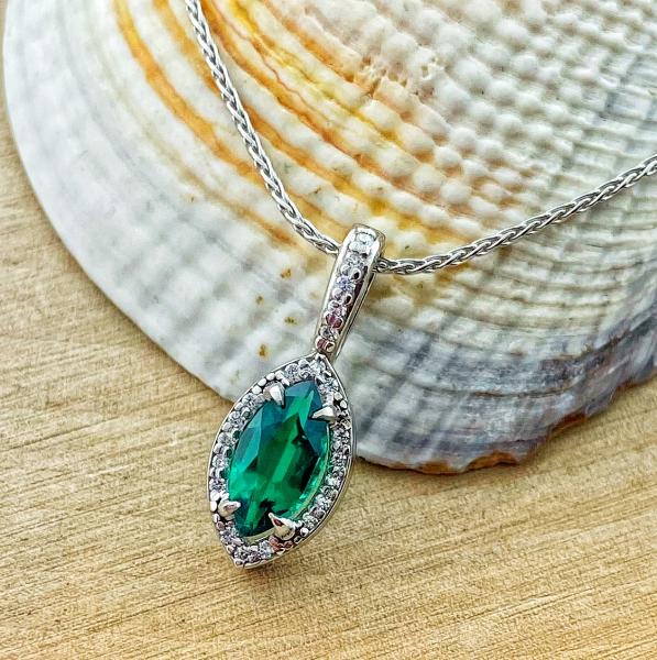 14 karat white gold lab created emerald and diamond halo necklace. *sold*