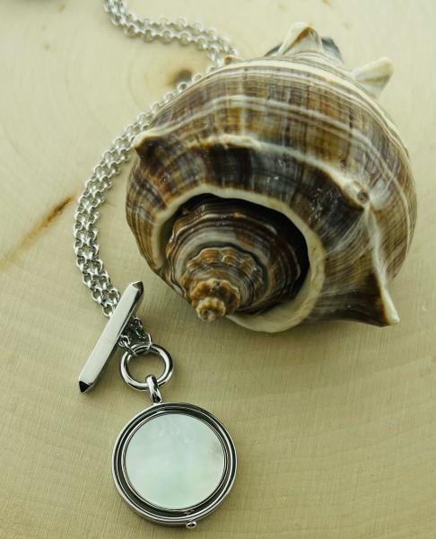 Sterling silver mother of pearl spinner pendant with bar & 18" chain. $265.00