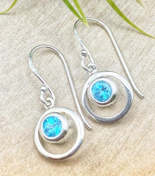 Sterling silver and Swiss blue topaz circle earrings. $70.00