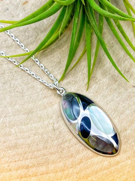 Sterling silver black, white, gray mother of pearl pendant on 18" chain. $150.00