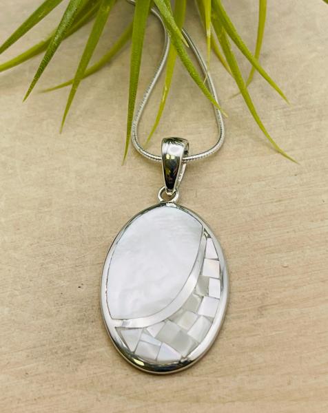 Sterling silver oval white mother of pearl mosaic pendant on 18" chain. $125.00 
