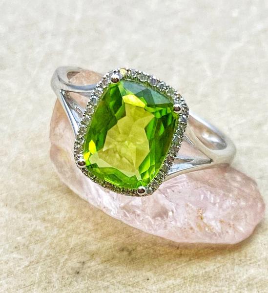 14 karat white gold 2.01ct cushion peridot .08ctw diamond halo split shank ring. $955.00