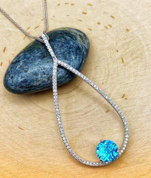 18 karat white gold teardrop necklace with 102 brilliant cut diamonds and a 2.50 carat Swiss blue topaz. Designed by Kurt Rose. $3150.00 **Sold, may be special ordered**