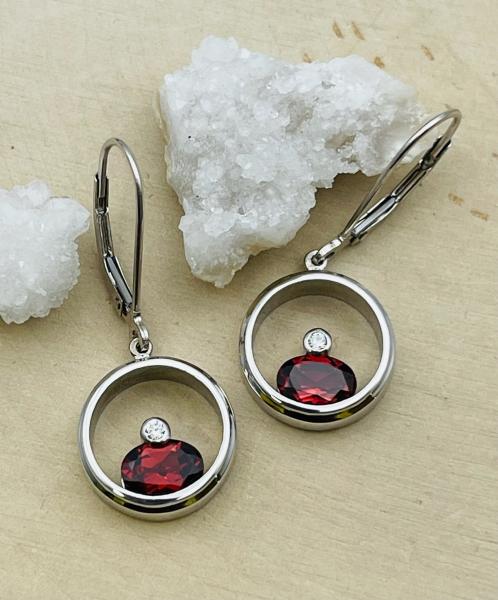 18 karat white gold garnet circle drop earrings. $975.00