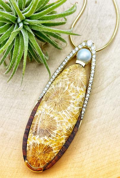 18 karat yellow gold necklace with a 30.43 carat fossilized coral, brilliant cut diamonds, freshwater pearl and carved desert ironwood. $5740.00. **SOLD***Designed by Rick Little