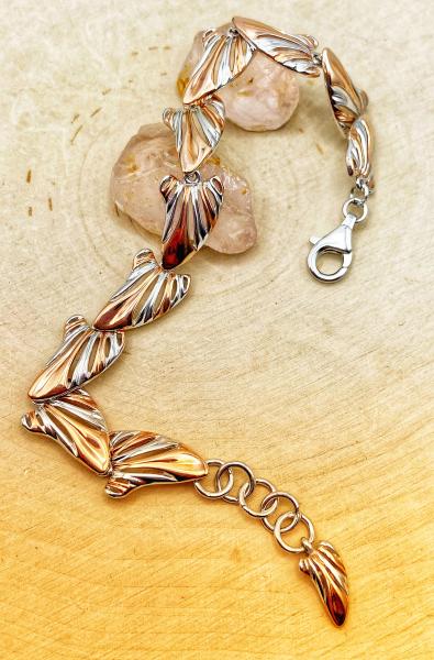 Sterling silver and 18 karat rose gold vermeil wing link bracelet. $745.00