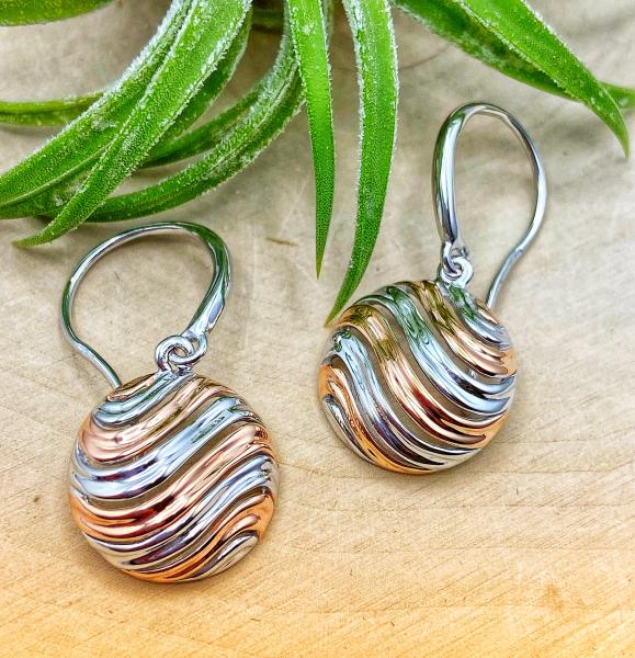 Sterling silver and 18 karat rose gold vermeil swirl disc earrings. $198.00