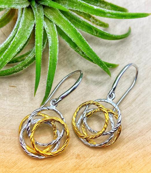 Sterling silver and 18 karat yellow gold vermeil nest earrings. $198.00
