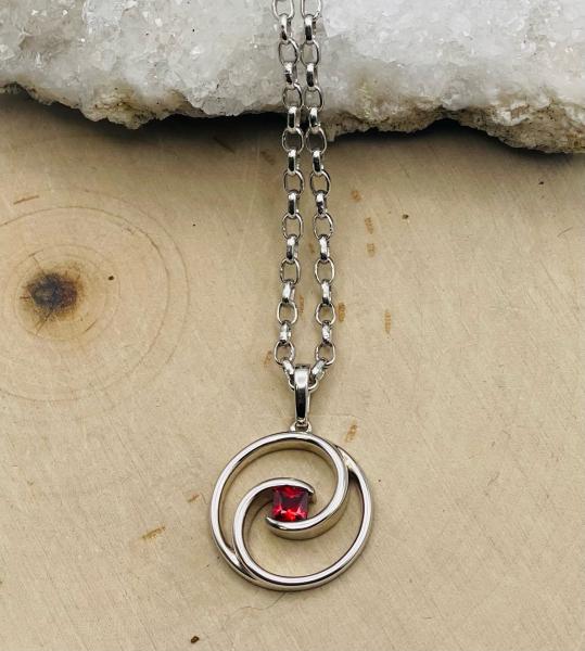 Sterling silver round .23ctw ruby swirl pendant on chain. $234.00
