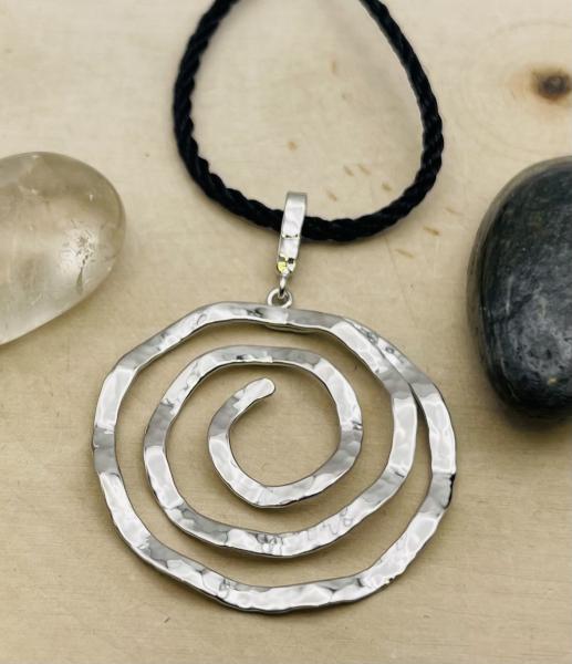 Sterling silver hammered spiral pendant on silk 18" cord. $145.00