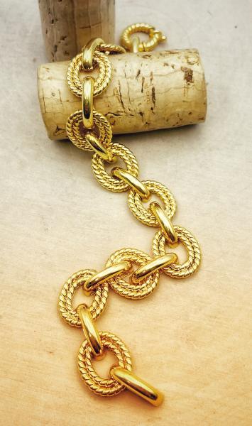 14 karat yellow gold textured and polished link bracelet. $1650.00