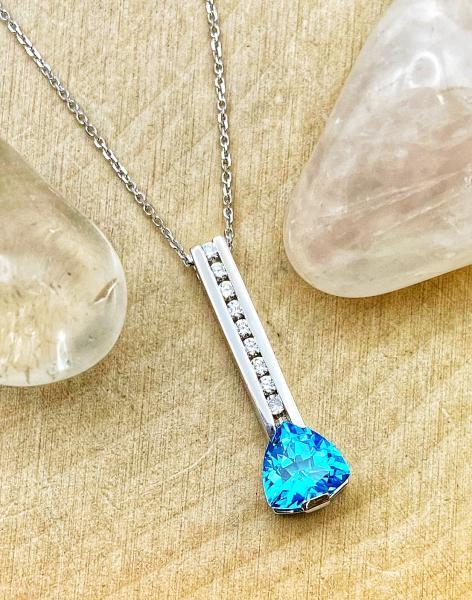 18 karat white gold trillion cut Swiss blue topaz and diamond bar necklace. $1350.00