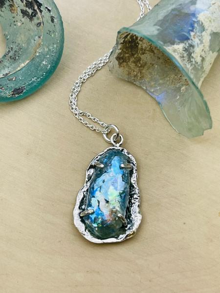 Sterling silver roman glass free-form pendant on chain. $215.00