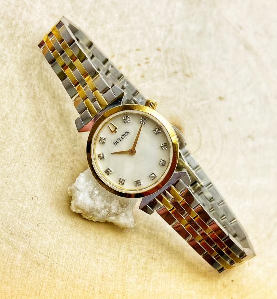 Ladies Bulova stainless steel rose gold two tone watch, mother of pearl face, diamond markers. $450.00