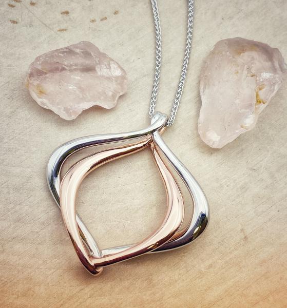 Sterling silver and 18 karat rose gold vermeil intertwined necklace. $375.00