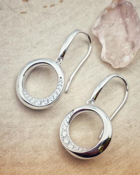 Sterling silver and cubic zirconia beveled circle earrings. $156.00