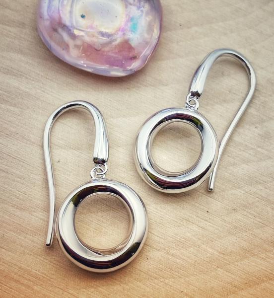Sterling silver beveled circle dangle earrings. $110.00