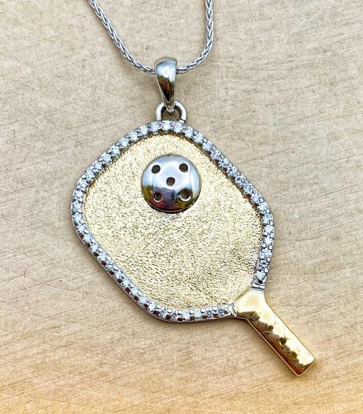14 karat yellow and white gold pickleball racquet with 46 brilliant cut lab grown diamonds and a 16" white gold wheat chain. $1300.00