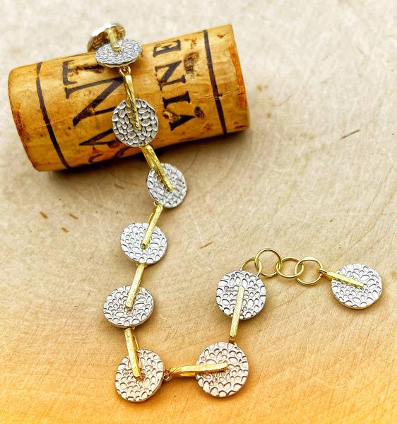 Sterling silver and 18 karat gold vermeil textured disc bracelet. $395.00