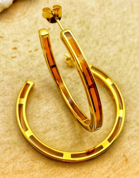 Sterling silver and 14 karat vermeil amber color resin hoop earrings. $450.00