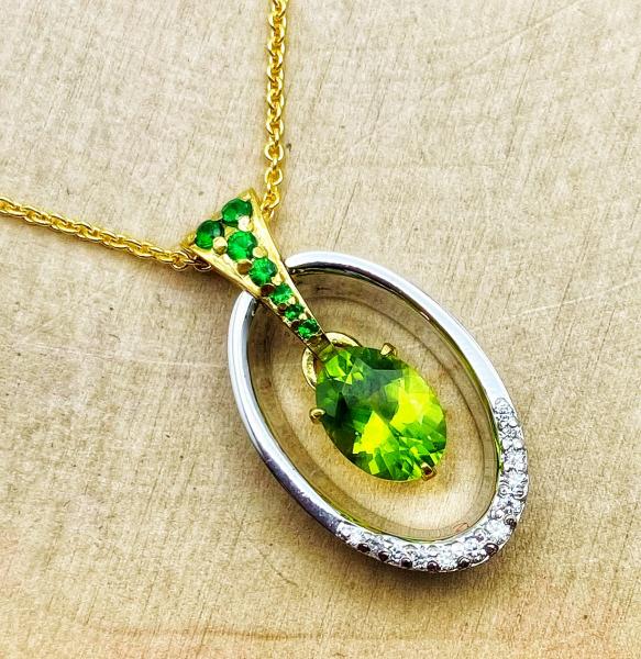 18 karat white and yellow gold peridot, tsavorite garnet and diamond necklace. $1600.00