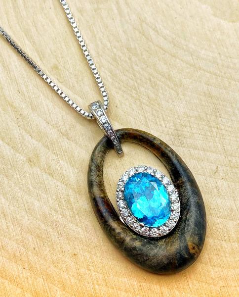 18 karat white gold necklace with a 4.31 carat blue zircon, burl wood and 28 brilliant cut diamonds. $4150.00 **SOLD**