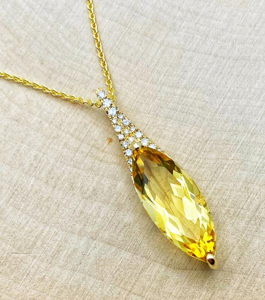 14 karat yellow gold necklace with a 2.65 carat marquise cut citrine accented with brilliant cut diamonds. $1175.00