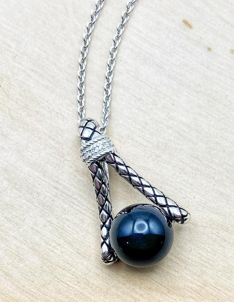 Sterling silver necklace with a 10mm onyx bead and diamond accents. $325.00