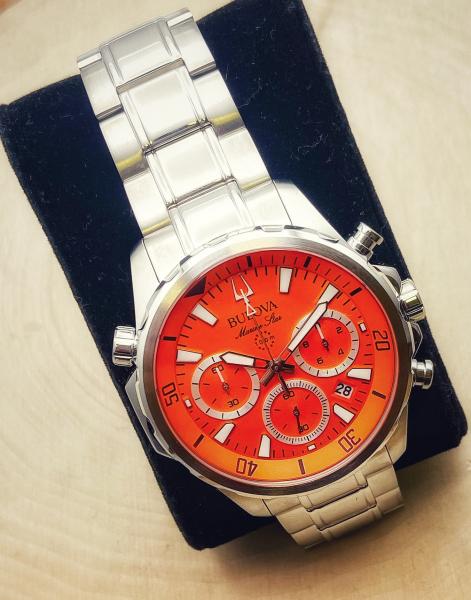 Stainless Steel Bulova Marine Star chronograph with orange dial. $525.00