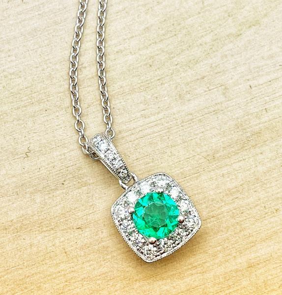 14 karat white gold emerald and diamond necklace. $2825.00