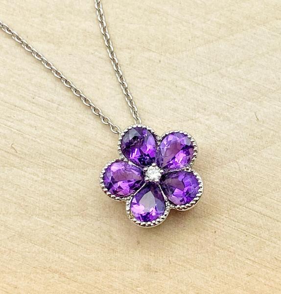 14 karat white gold amethyst and diamond flower necklace. $680.00