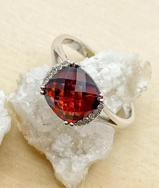 14 karat white gold cushion checkerboard cut garnet and diamond ring. $730.00