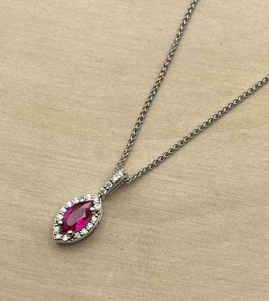 14 karat white gold marquise ruby and diamond halo necklace. $1,335.00