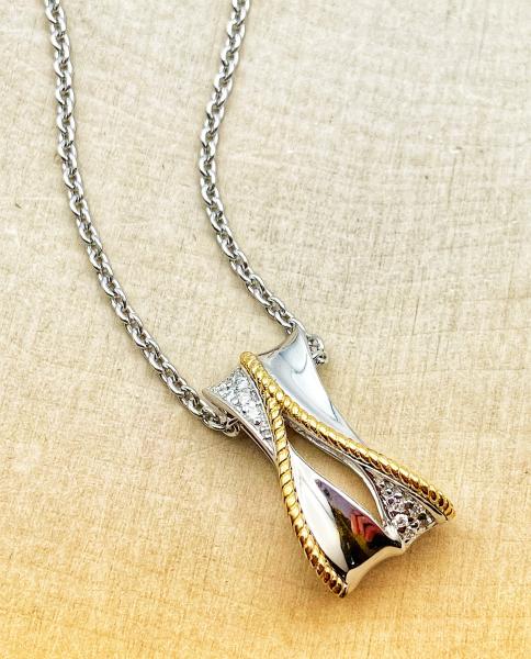 Sterling silver and 18 karat yellow gold diamond necklace. $425.00