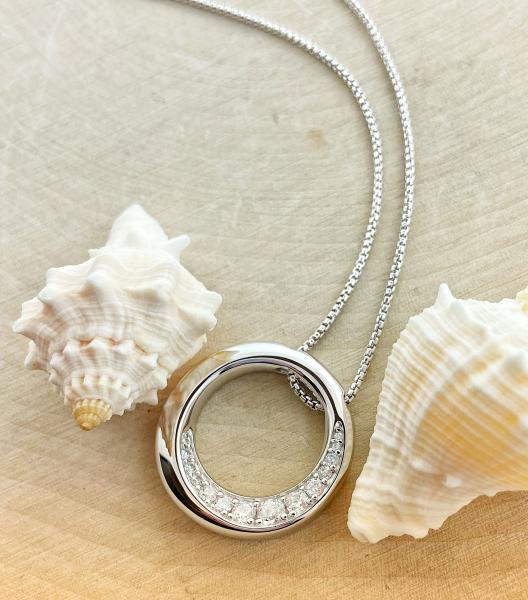 Sterling silver beveled circle cubic zirconia necklace. $240.00