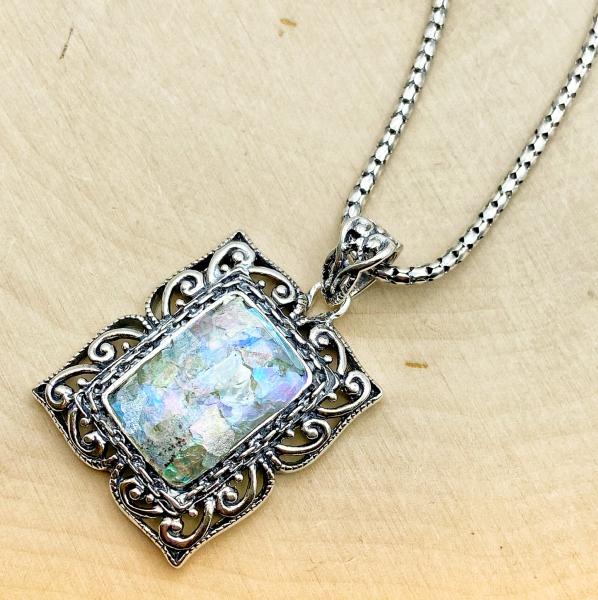 Sterling silver rectangular scroll framed Roman glass necklace. $480.00