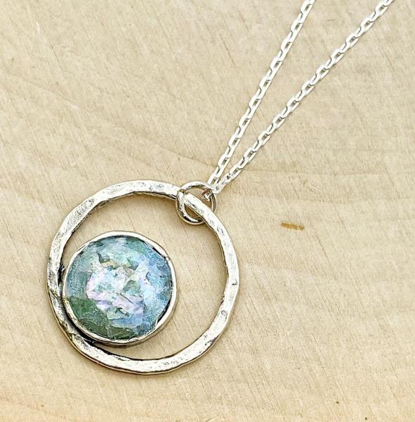 Sterling silver off-center round Roman glass necklace. $165.00