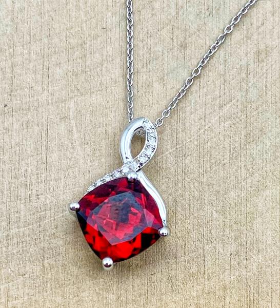 14 karat white gold cushion cut garnet and diamond necklace. $770.00