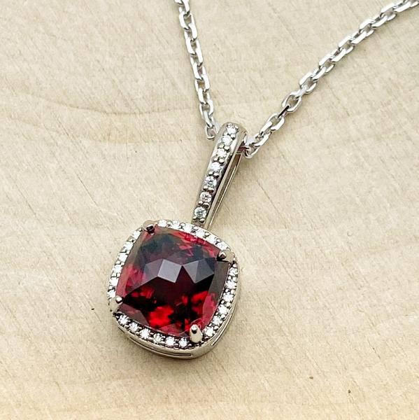 14 karat white gold custom cushion cut garnet and diamond necklace. $1,270.00