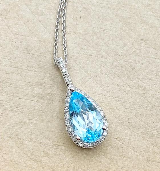 14 karat white gold necklace with a 1.28 carat pear shape blue topaz and diamonds. $710.00