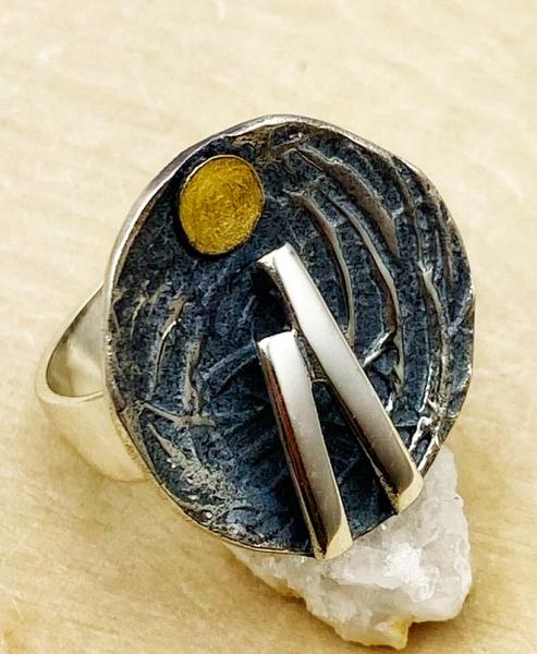 Sterling silver and 18 karat gold nest ring. $250.00