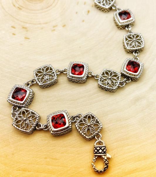 Sterling silver checkerboard cut garnet and filigree link bracelet. $650.00