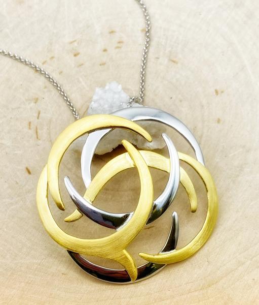 Sterling silver and 18 karat gold vermeil shield design necklace. $480.00