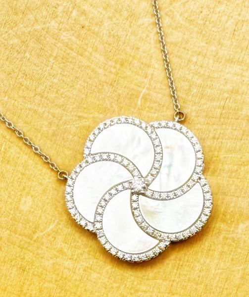 14 karat white gold mother of pearl and diamond necklace. $3780.00