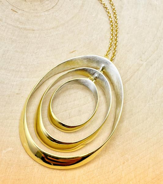 Sterling silver and 18 karat vermeil triple oval necklace. $$360.00