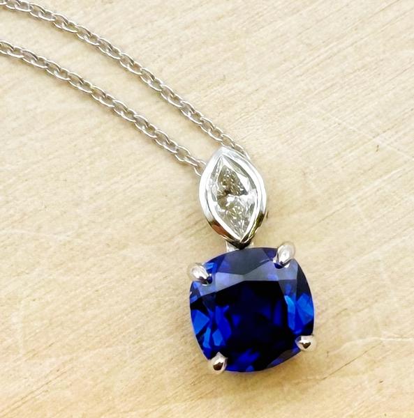 14 karat white gold cushion cut lab grown blue sapphire and marquise diamond necklace. $1,870.00